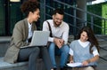 Group of three young business people experts in marketing telecommuting financial and strategy, talking outside office building. Royalty Free Stock Photo