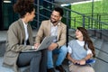 Group of three young business people experts in marketing telecommuting financial and strategy, talking outside office building. Royalty Free Stock Photo