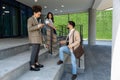 Group of three young business people experts in marketing telecommuting financial and strategy, talking outside office building. Royalty Free Stock Photo