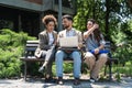 Group of three young business people experts in marketing telecommuting financial and strategy, talking outside office building. Royalty Free Stock Photo