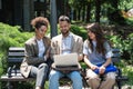 Group of three young business people experts in marketing telecommuting financial and strategy, talking outside office building. Royalty Free Stock Photo