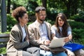 Group of three young business people experts in marketing telecommuting financial and strategy, talking outside office building. Royalty Free Stock Photo