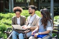 Group of three young business people experts in marketing telecommuting financial and strategy, talking outside office building. Royalty Free Stock Photo