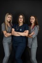 Group of three young female doctor or nurse wear uniform stethoscope isolated on black Royalty Free Stock Photo