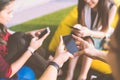 Group of three young people using smartphones together, modern lifestyle or communication technology gadget concept Royalty Free Stock Photo