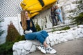 Group of three young Stylish nice girls in pantsuit costumes sitting on a stairs near white construction Royalty Free Stock Photo