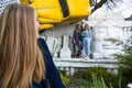 Group of three young Stylish nice girls in pantsuit costumes sitting on a stairs near white construction Royalty Free Stock Photo