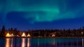 Group of Tipi and smooth water reflection under Northern light in Yellow knife village