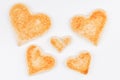 Group of toasted bread hearts with one broken heart together on white background