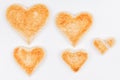 Group of toasted bread hearts with one broken heart together on white background