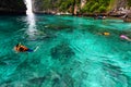 Group of Tourism on trip in life jacket with diving mask is snorkeling among many Indo- Pacific sergeant fish