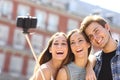 Group of tourist friends taking selfie with smart phone