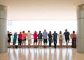 Group of tourist people from behind standing at balustratde look