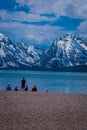 Group of tourist sitting in the ground enjoying the landscape of Grand Teton National Park, Wyoming, reflection of