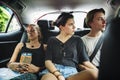 Group of tourist sitting in the taxi backseat doing sight seeing tour