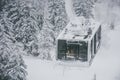 Group of tourist and skiers carries skis and equipments in cable car to the track on a slope for skiing on Mount Asahi