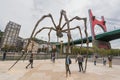Group of tourist visiting Louise Bourgeois giant 11 meter high spider of the Guggenheim museum in Bilbao, Spain.