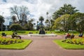 Group of tourist visitors relaxing and resting on the chair around a large cast iron fountain in Albert Park. Royalty Free Stock Photo