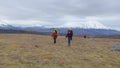 A group of tourists against the backdrop of the majestic beautiful volcanoes of Kamchatka