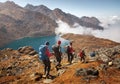 Group tourists with Backpacks descends down on Mountain Trail du