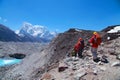 Group of tourists with backpacks descends down mountain trail to lake during a way to Everest base camp. Nepal Royalty Free Stock Photo