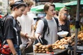 Group of tourists buying Thai Food at food stall