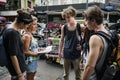 Group of tourists checking on Bangkok Thailand travel guide book