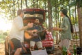 Group tourists drinking beer-alcohol and play guitar together with enjoy and happiness in Summer while camping Royalty Free Stock Photo