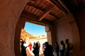 Group of tourists enters the central gate of ancient Berber fortress - Ksar Ait Ben Haddou