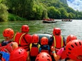 Tourists having fun doing water rafting point of view shot