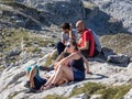 Group of tourists, hikers sitting and admiring mountains in Cantabria, Picos de Europa