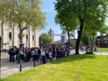 A group of tourists listening to a guided tour of the Tower of London on a beautiful sunny day in London, England. Royalty Free Stock Photo