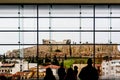 Group of tourists look out large modern window to Partenon on Athens Accropolis in Greece on rainy day