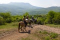 Group of tourists on the mountain equestrian trip on horses around the Ghost valley