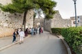 Group of tourists near the entrance to the medieval Venus Castle in historic town Erice.