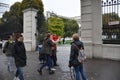 A group of tourists and passersby outside the park gate in Vienna