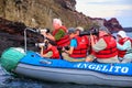 Group of tourists photographing from a dinghy near Bartolome isl