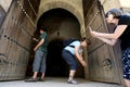 A group of tourists photographing the doors to the old grainaries of the Heri es-Souni in Meknes, Morocco.