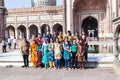 Group of tourists pose for a photo in front of the Jama Masjid Mosque in Old Delhi Royalty Free Stock Photo