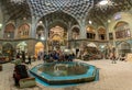 Group of tourists resting in the Aminoddole Caravanserai of Grand Bazaar of Kashan, Iran