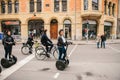Berlin, October 3, 2017: Group of tourists riding on gyroscooters along the streets of Berlin during excursion. Cyclists