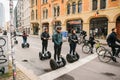 Berlin, October 3, 2017: Group of tourists riding on gyroscooters along the streets of Berlin during excursion. Cyclists