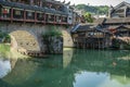 Tourists in old wooden boat in Fenghuang