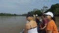 Group of tourists sailing in a wooden boat on the Aguarico river on a sunny morning Royalty Free Stock Photo