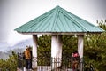 Group of tourists stands in a scenic mountain pavilion. Shillong Peak, Meghalaya, India.