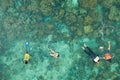 Group of tourists are swimming in blue sea. Snorkeling in full-face snorkeling mask. Coral reef in shallow sea. Snorkel undersea. Royalty Free Stock Photo