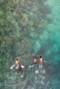 Group of tourists are swimming in blue sea. Snorkeling in full-face snorkeling mask. Coral reef in shallow sea. Snorkel undersea. Royalty Free Stock Photo