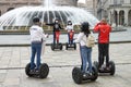 A group of tourists take a tour of Genoa on Segway scooters