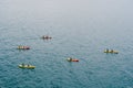 A group of tourists travel in pairs kayaks by sea, near old town of Dubrovnik, Croatia. Concept banner travel. Aerial