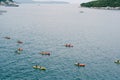 A group of tourists travel in pairs kayaks by sea, near old town of Dubrovnik, Croatia. Concept banner travel. Aerial